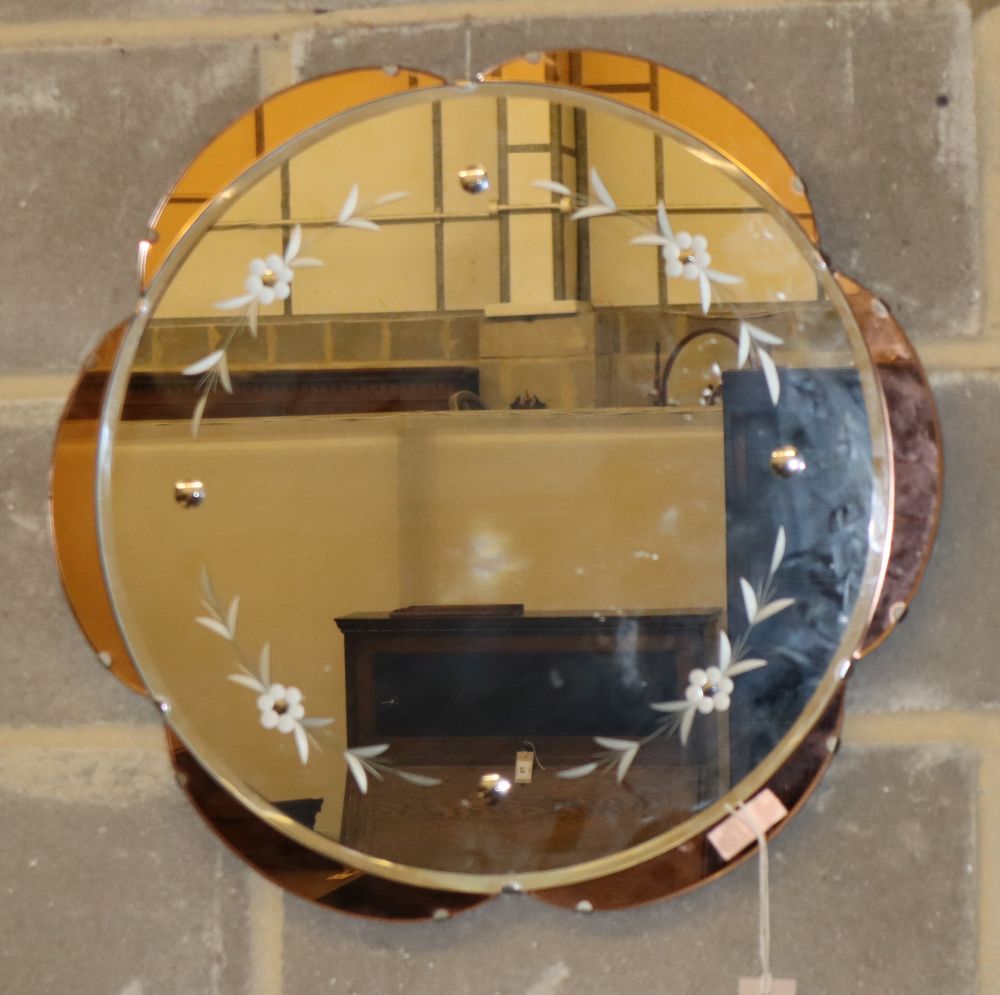 A 1950s peach and etched clear glass circular wall mirror, 57cm diameter